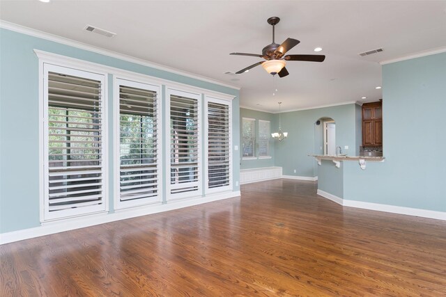 dining area with an inviting chandelier, crown molding, and dark hardwood / wood-style floors