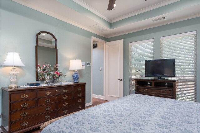 bedroom with ceiling fan, dark wood-type flooring, and ornamental molding