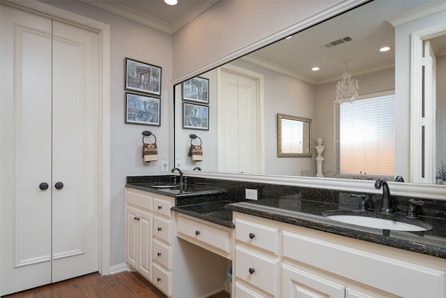 bathroom featuring wood-type flooring, vanity, and ornamental molding