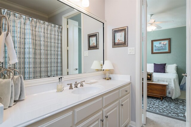 bathroom featuring ceiling fan, vanity, and ornamental molding