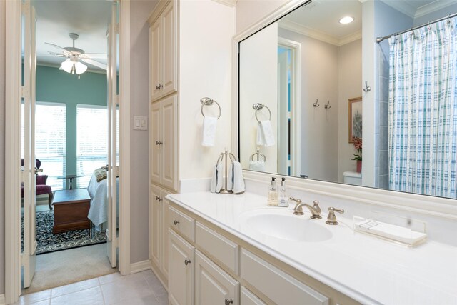 bathroom featuring toilet, ceiling fan, tile patterned flooring, crown molding, and vanity