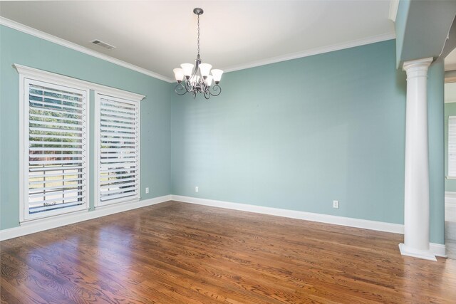 living room with plenty of natural light, dark hardwood / wood-style floors, ornamental molding, and a chandelier