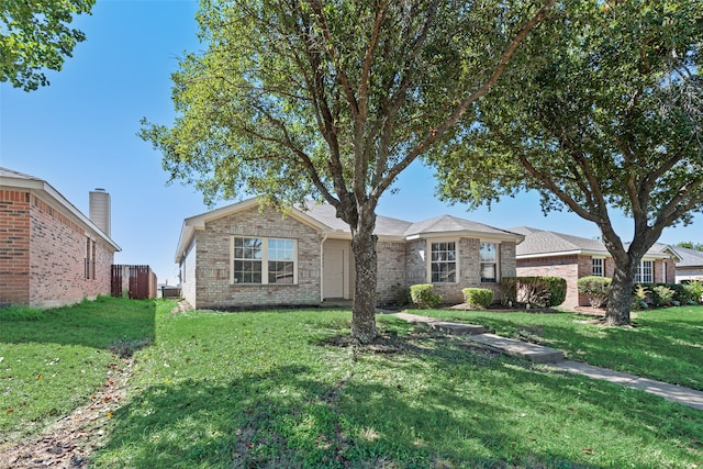 single story home with central AC and a front yard