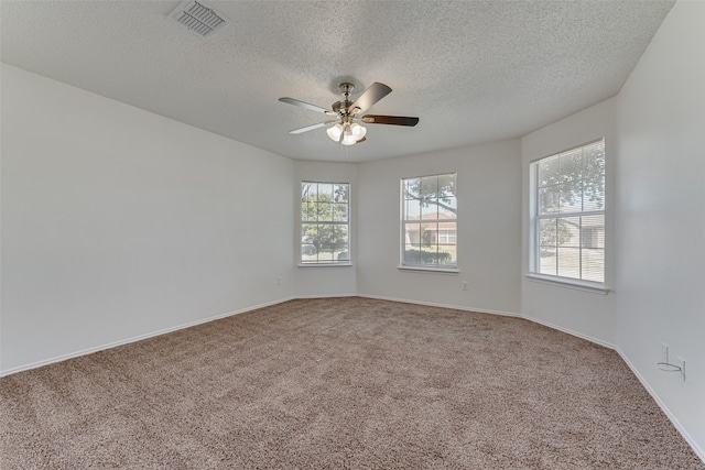 carpeted spare room featuring a textured ceiling and ceiling fan