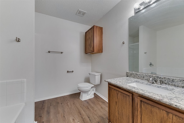 full bathroom with vanity, a textured ceiling, toilet, shower with separate bathtub, and hardwood / wood-style floors