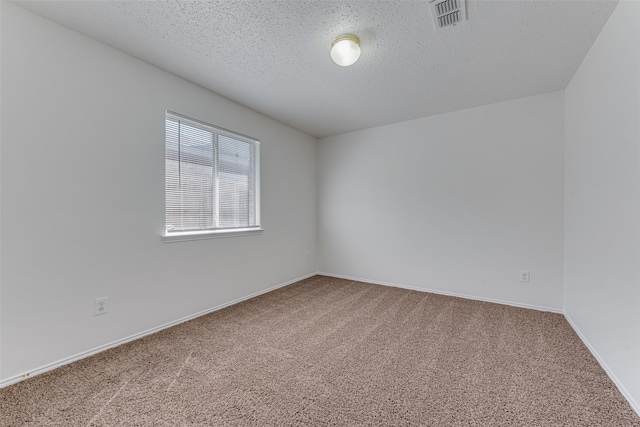 carpeted spare room featuring a textured ceiling