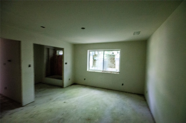 unfurnished room featuring light carpet