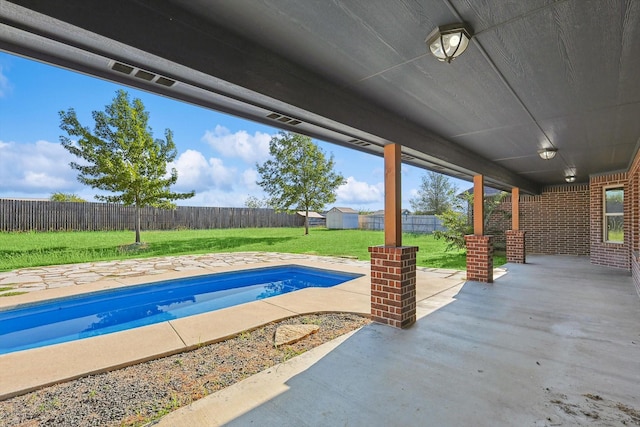 view of pool with a yard and a patio area