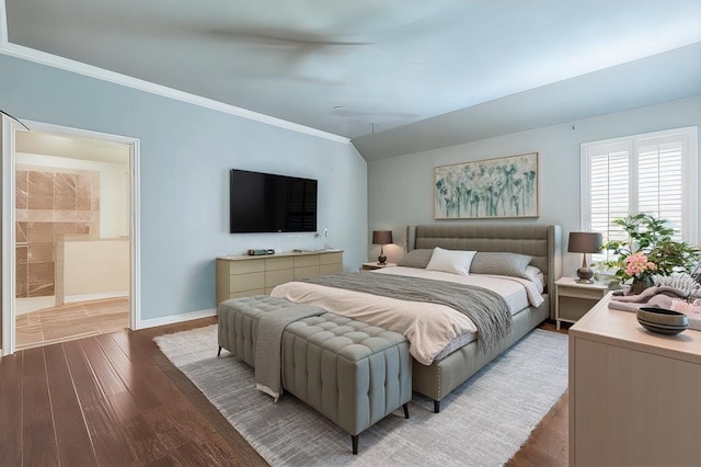 bedroom with vaulted ceiling and hardwood / wood-style floors