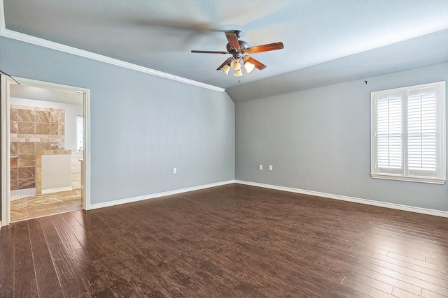 unfurnished room featuring crown molding, lofted ceiling, dark hardwood / wood-style floors, and ceiling fan