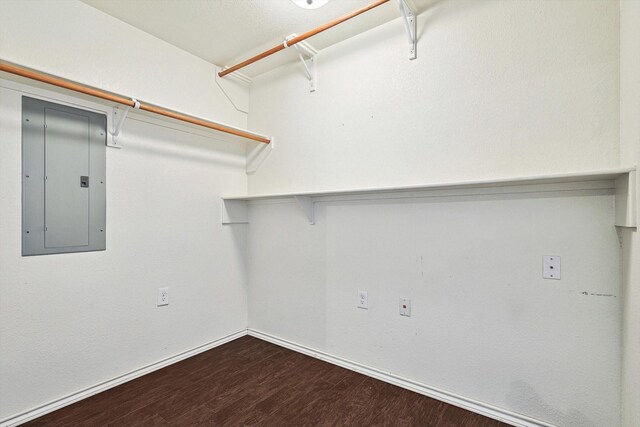 unfurnished room with lofted ceiling, dark wood-type flooring, crown molding, ceiling fan, and a fireplace