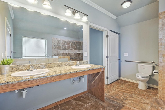 bathroom with lofted ceiling, crown molding, double sink, and toilet