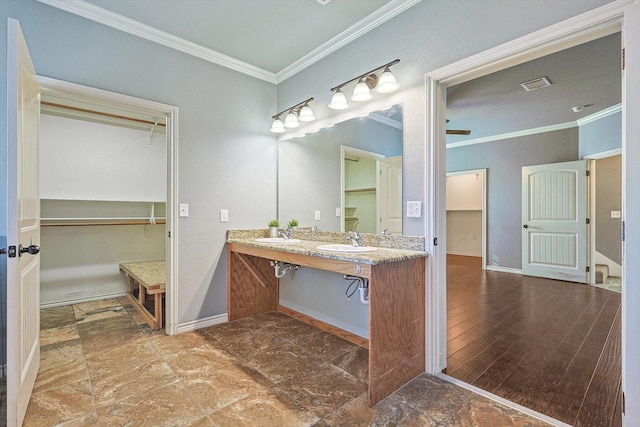 bathroom featuring ornamental molding, hardwood / wood-style floors, and vanity