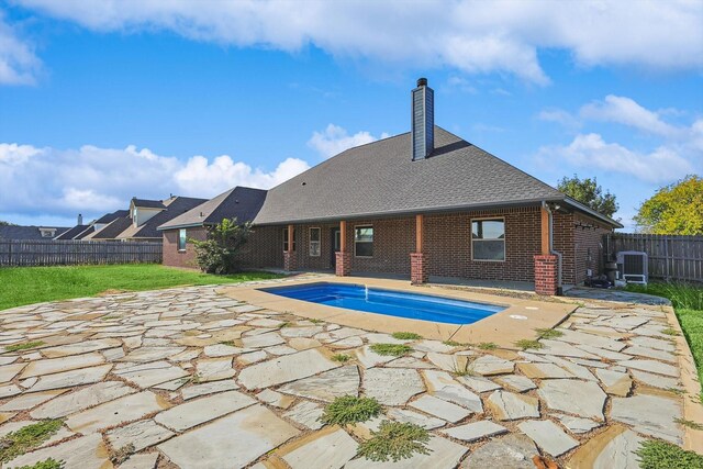 view of pool with a yard and a storage shed