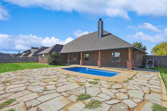 view of pool with a patio, a yard, and cooling unit