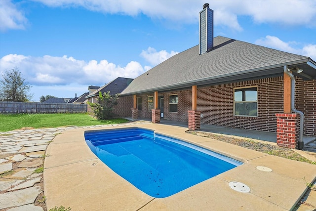 view of pool featuring a yard and a patio