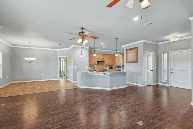 unfurnished living room with ceiling fan with notable chandelier, dark wood-type flooring, ornamental molding, and a textured ceiling