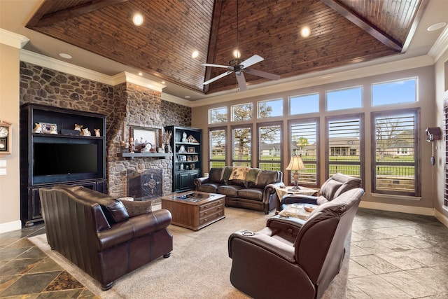 living room featuring a fireplace, wooden ceiling, a high ceiling, ceiling fan, and ornamental molding