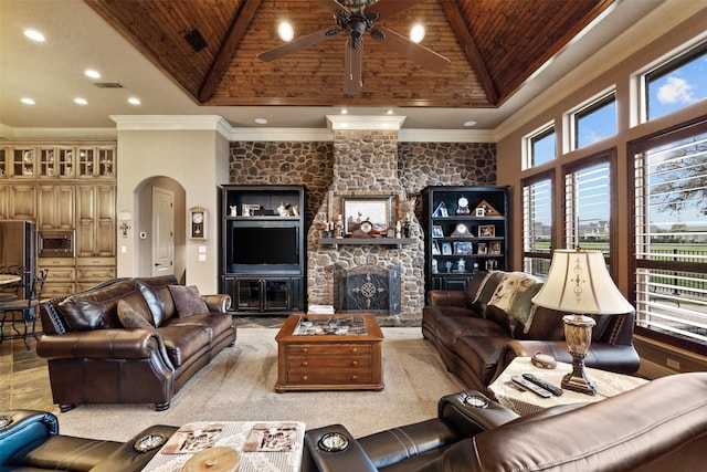 living room featuring high vaulted ceiling, a stone fireplace, wooden ceiling, ceiling fan, and ornamental molding