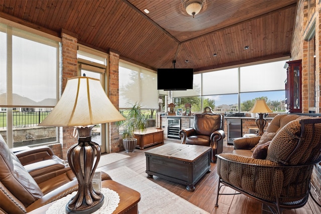 sunroom / solarium featuring beverage cooler, wooden ceiling, and a fireplace