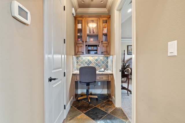 office space featuring built in desk and crown molding