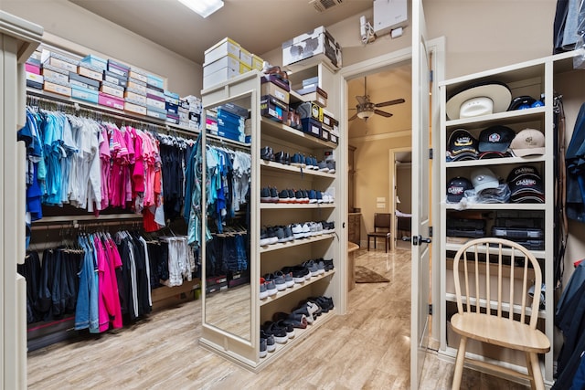 spacious closet featuring ceiling fan and wood-type flooring