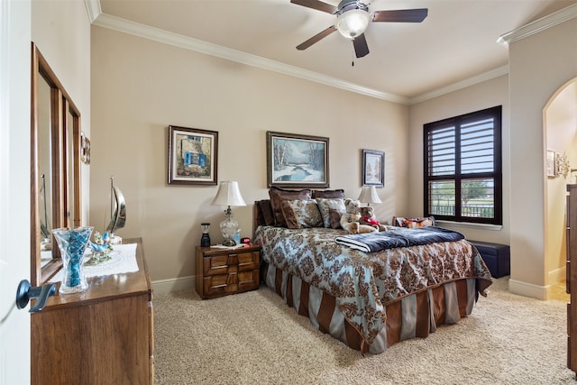 carpeted bedroom featuring ornamental molding and ceiling fan