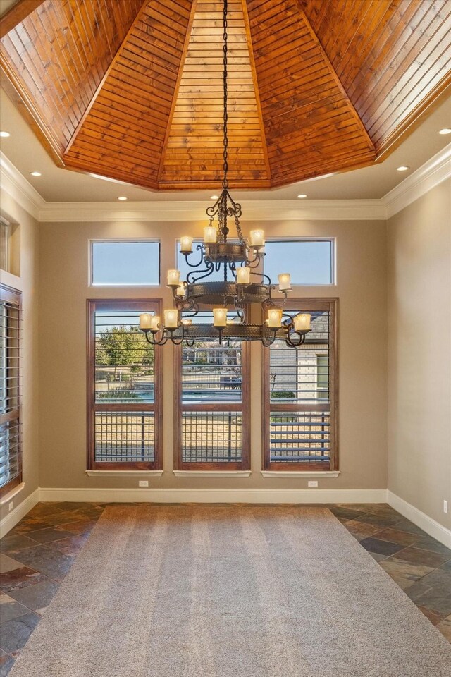 kitchen with a kitchen island with sink, tasteful backsplash, ornamental molding, stainless steel appliances, and light stone countertops