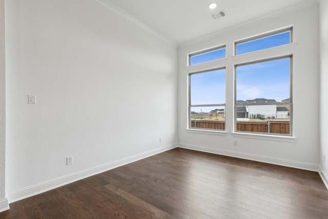 unfurnished room with dark hardwood / wood-style flooring and crown molding