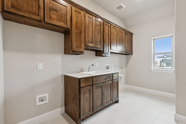 laundry area with electric dryer hookup, cabinets, hookup for a gas dryer, sink, and washer hookup