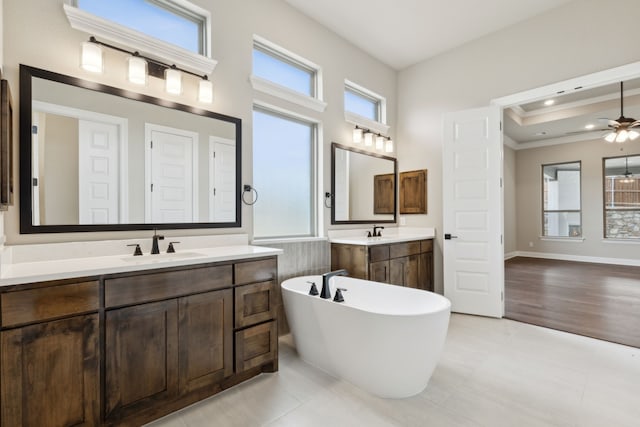 bathroom with a tub, ceiling fan, tile patterned flooring, and vanity