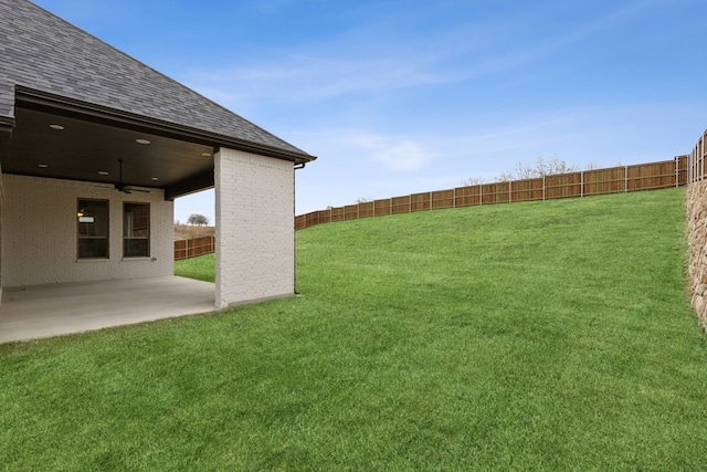 view of yard featuring a patio area and ceiling fan