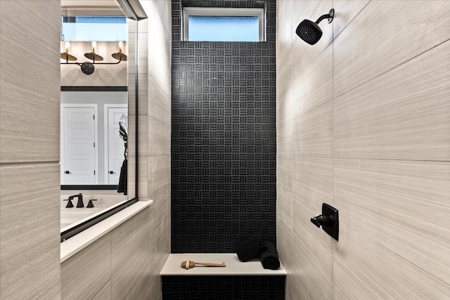 bathroom with a shower and tile walls