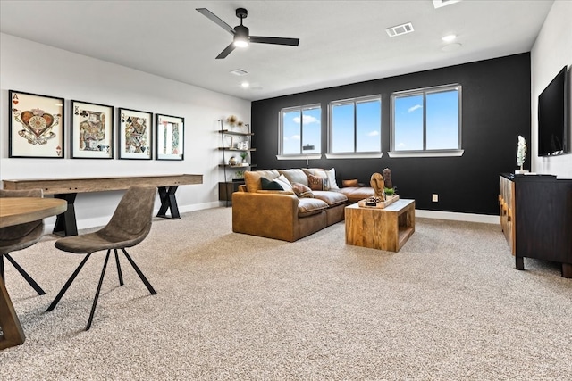 carpeted living room featuring ceiling fan