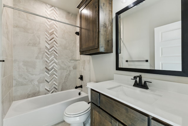 full bathroom featuring tiled shower / bath combo, vanity, and toilet