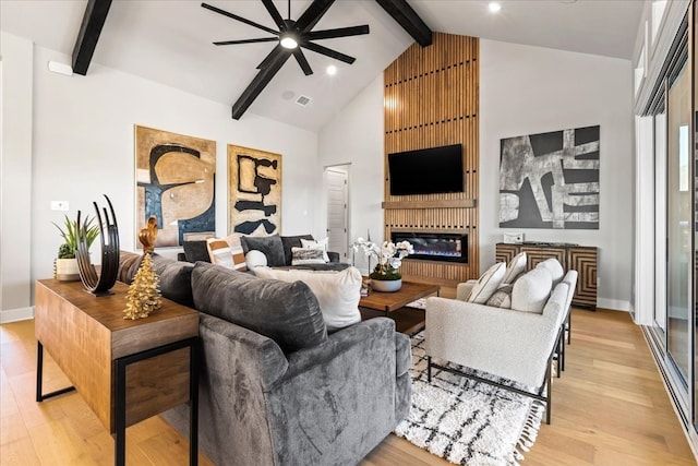 living room featuring beamed ceiling, ceiling fan, light hardwood / wood-style floors, and high vaulted ceiling