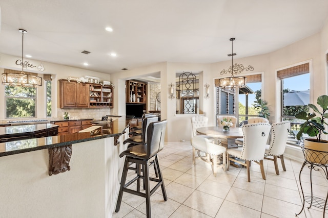 tiled dining area with a notable chandelier