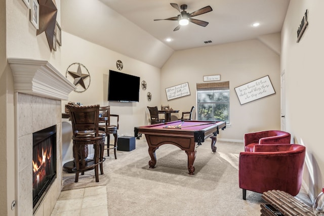 game room with a tile fireplace, ceiling fan, light colored carpet, vaulted ceiling, and pool table