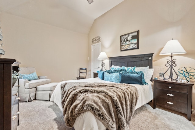 bedroom with light colored carpet and lofted ceiling