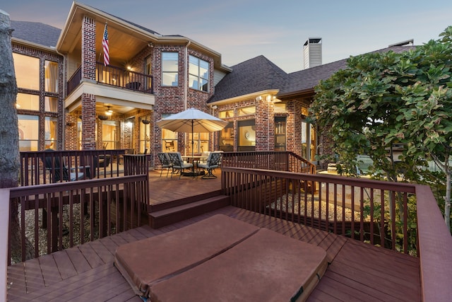 deck at dusk featuring ceiling fan