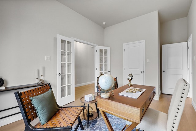 office area with light hardwood / wood-style flooring and french doors