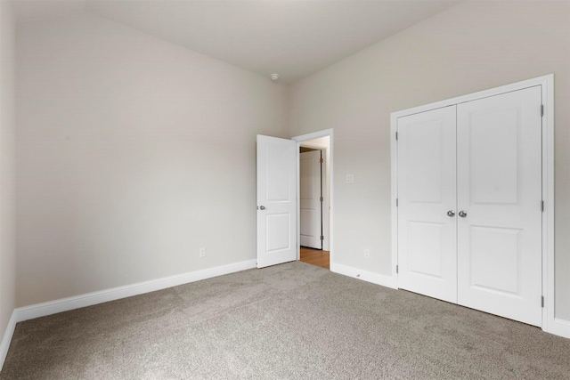 unfurnished bedroom featuring carpet flooring and a closet