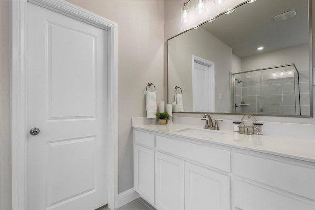 bathroom featuring vanity and a shower with shower door