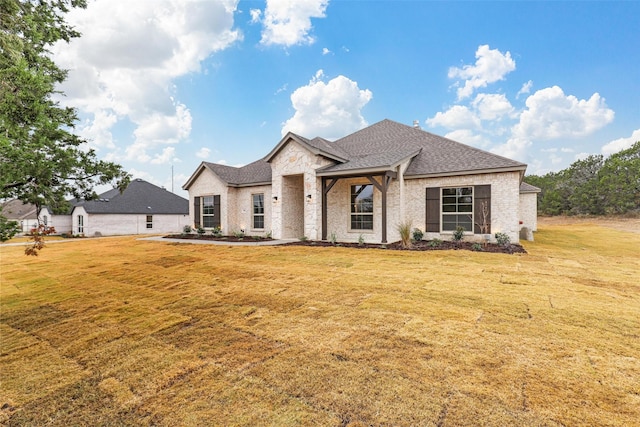 french country style house with a front yard