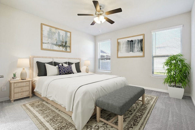 bedroom with light carpet, multiple windows, and baseboards