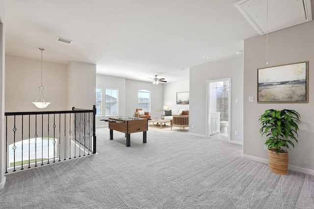 rec room with baseboards, visible vents, carpet floors, attic access, and ceiling fan