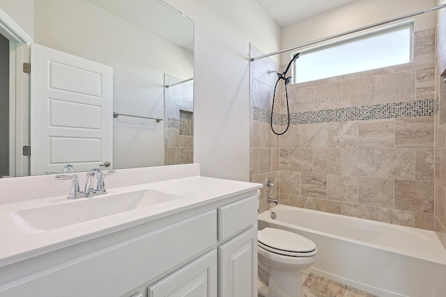 bathroom featuring vanity, toilet, and shower / washtub combination