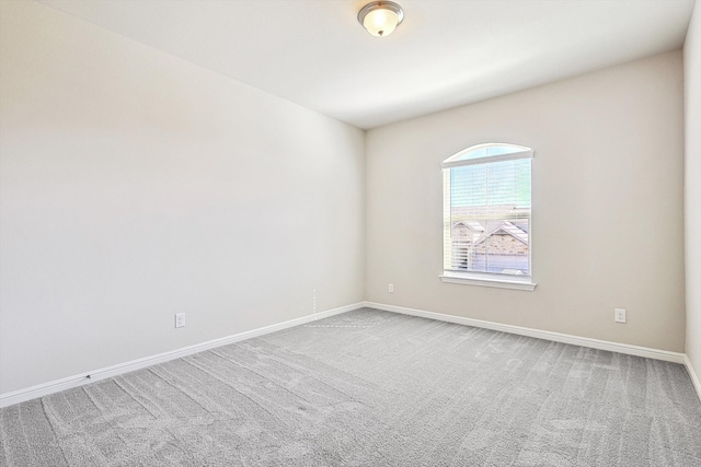 unfurnished room featuring baseboards and carpet floors