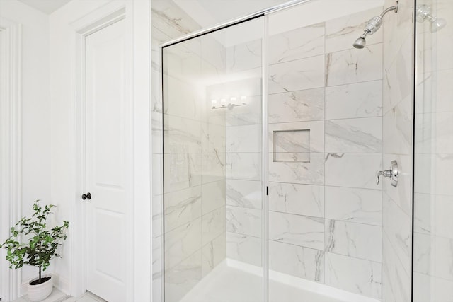 bathroom featuring a shower with door