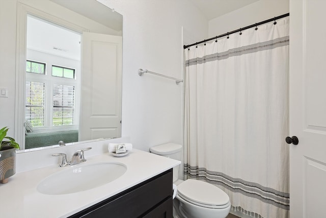 bathroom with toilet and vanity